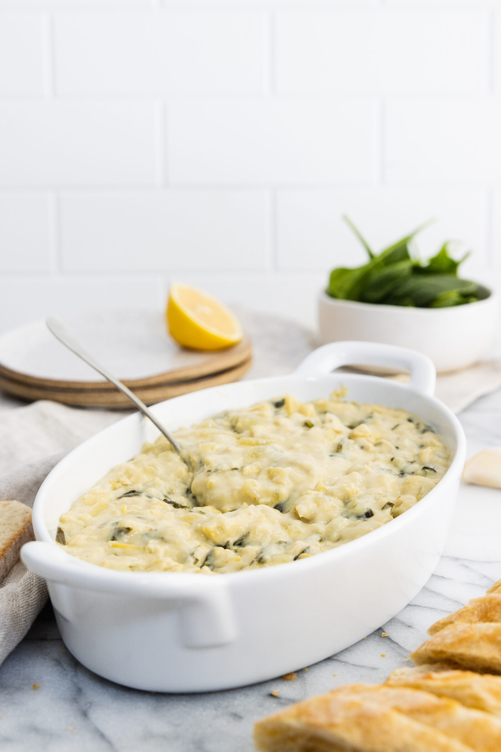 Vegan artichoke dip served with bread