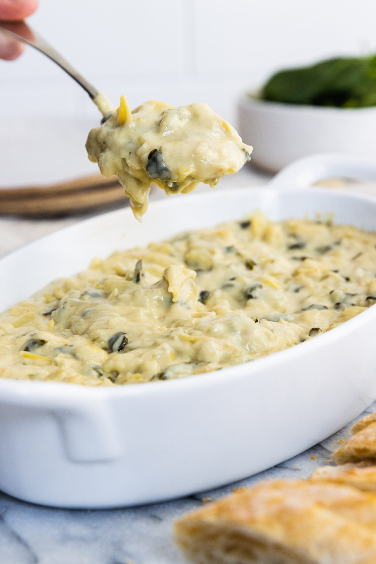 Spinach artichoke dip in a white baking dish