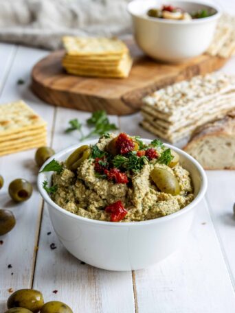 Green or Black Olive Tapenade served in a bowl with Crackers