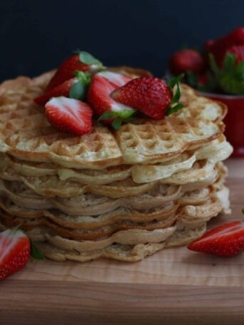 Fluffy Vegan Waffles served with fresh strawberries
