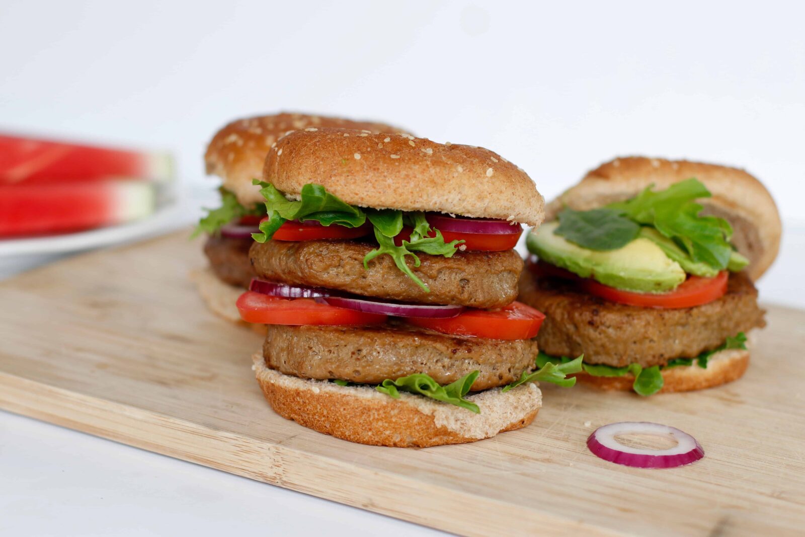 Vegan All-American Burgers served with lettuce, tomato, and red onion