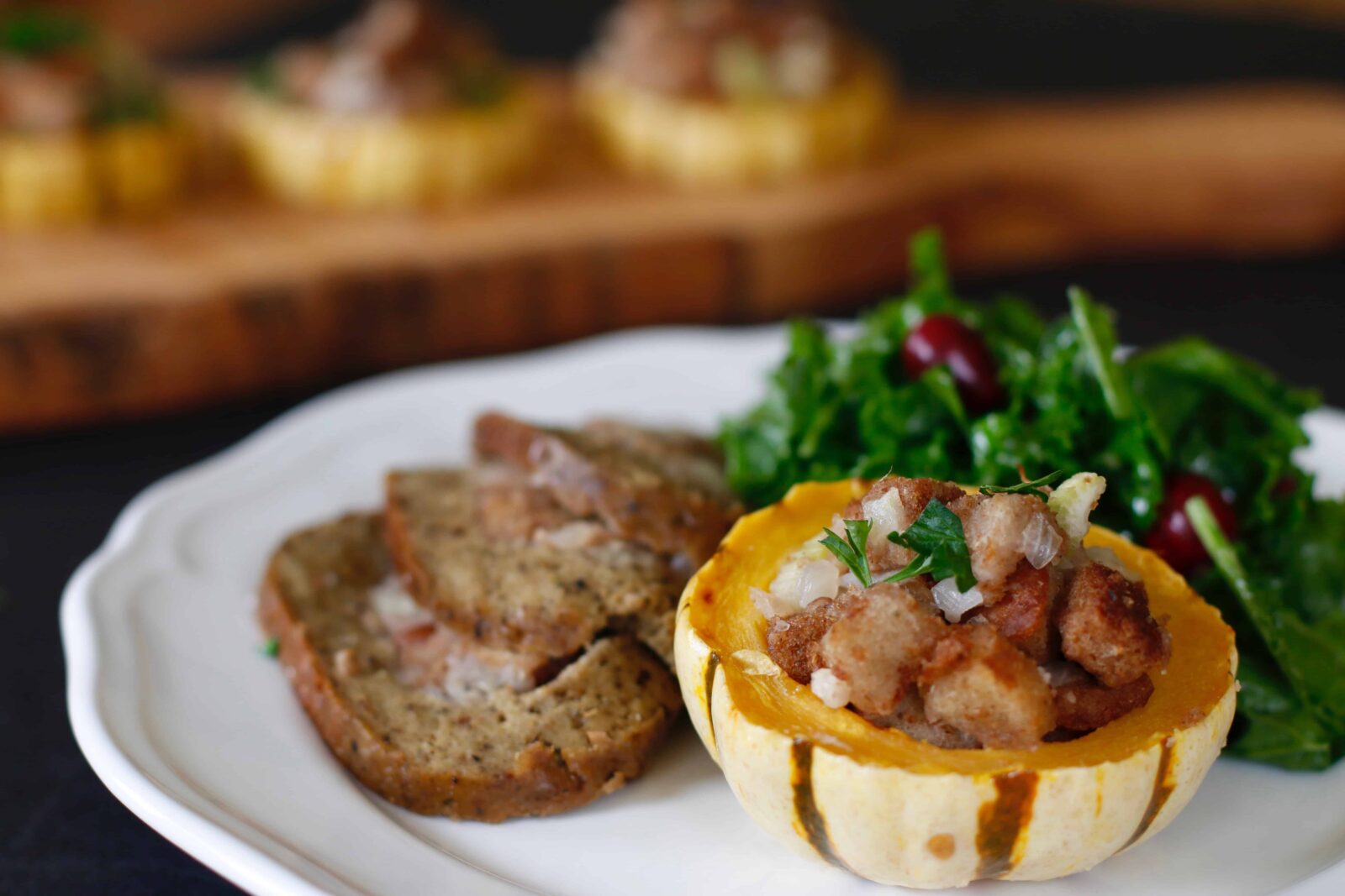 Roasted Delicata Squash served on a plate with salad