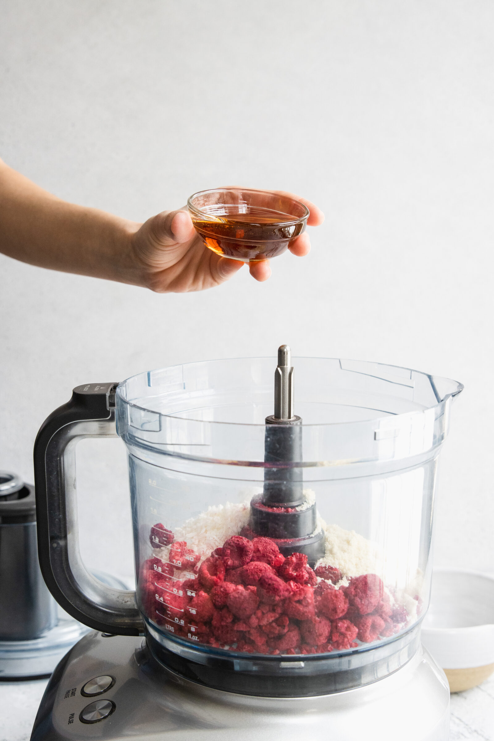 Adding maple syrup to the food processor