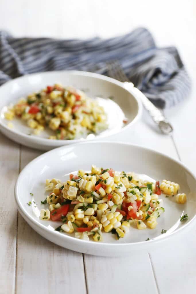 Vegan Fresh Corn Salad served on two white plates