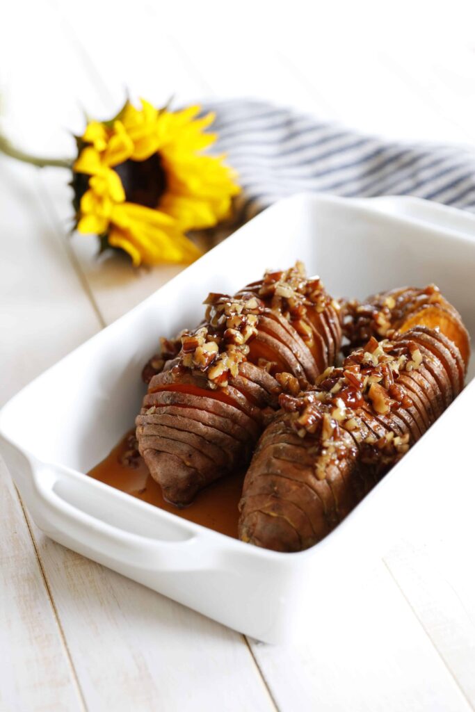 Maple Pecan Hasselback Sweet Potatoes served in a baking dish