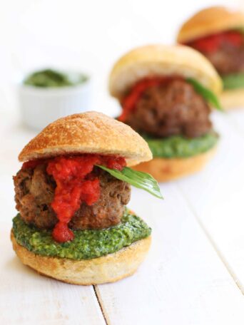 Vegan Meatball Sliders served with vegan pesto and marinara sauce