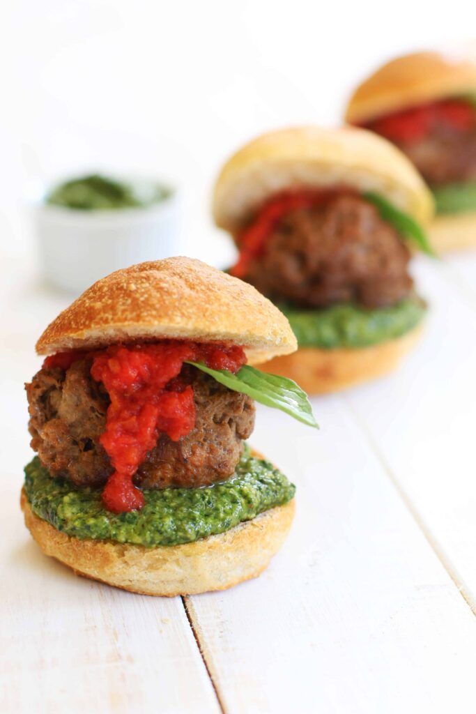 Vegan Meatball Sliders served with vegan pesto and marinara sauce