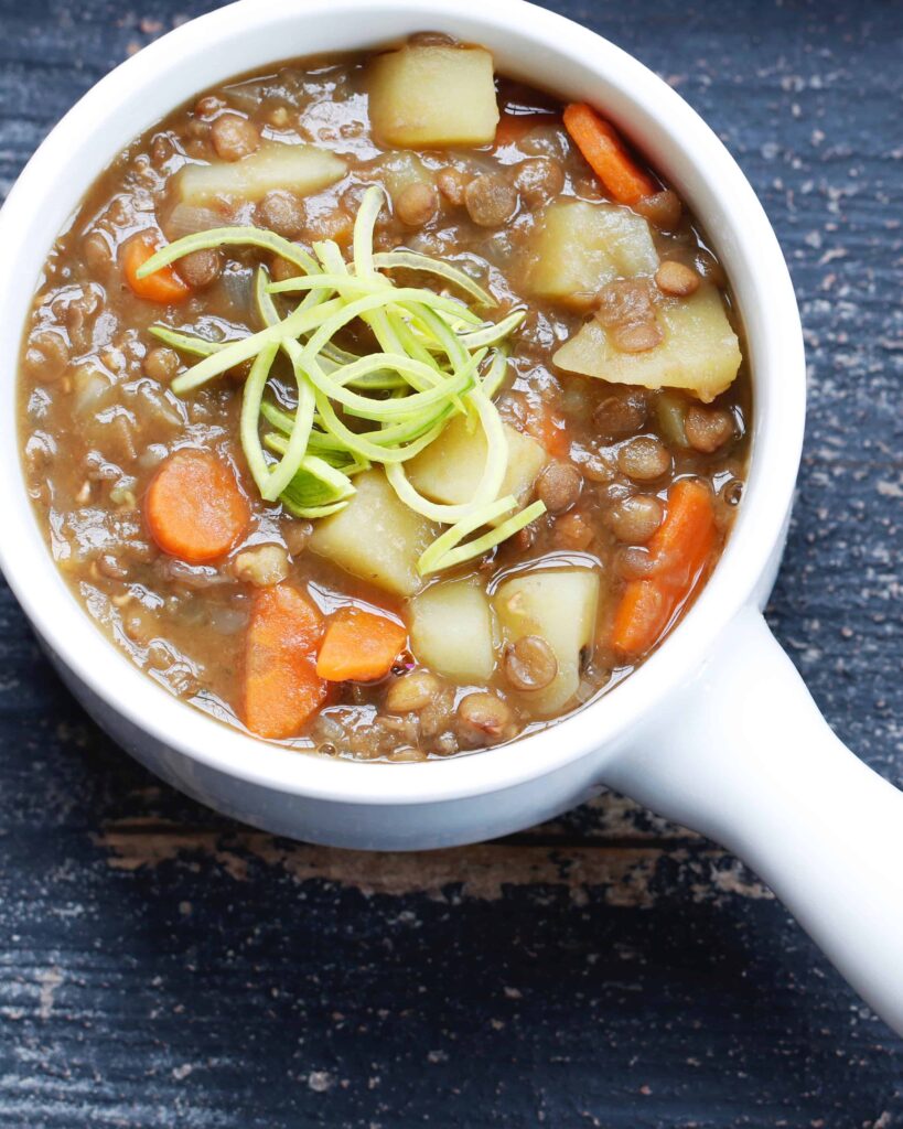 Hearty lentil stew served in a white bowl