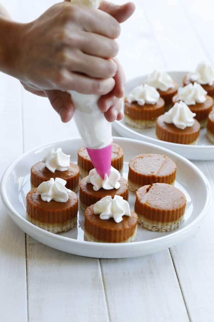 Decorating Vegan Pumpkin Pie Bites on a plate 