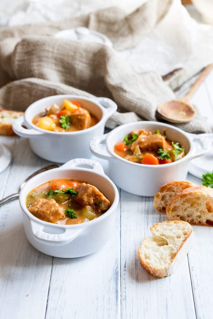 Vegan beef stew served with slices of fresh bread 