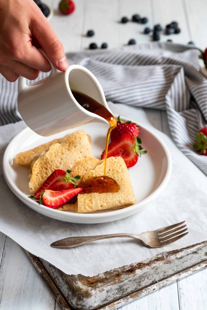 Vegan Crepes served with fresh strawberries and maple syrup