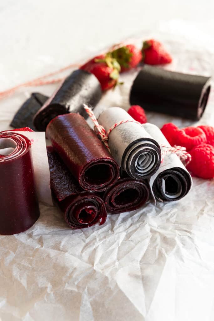 Fruit Leather rolled up with fresh raspberries and strawberries