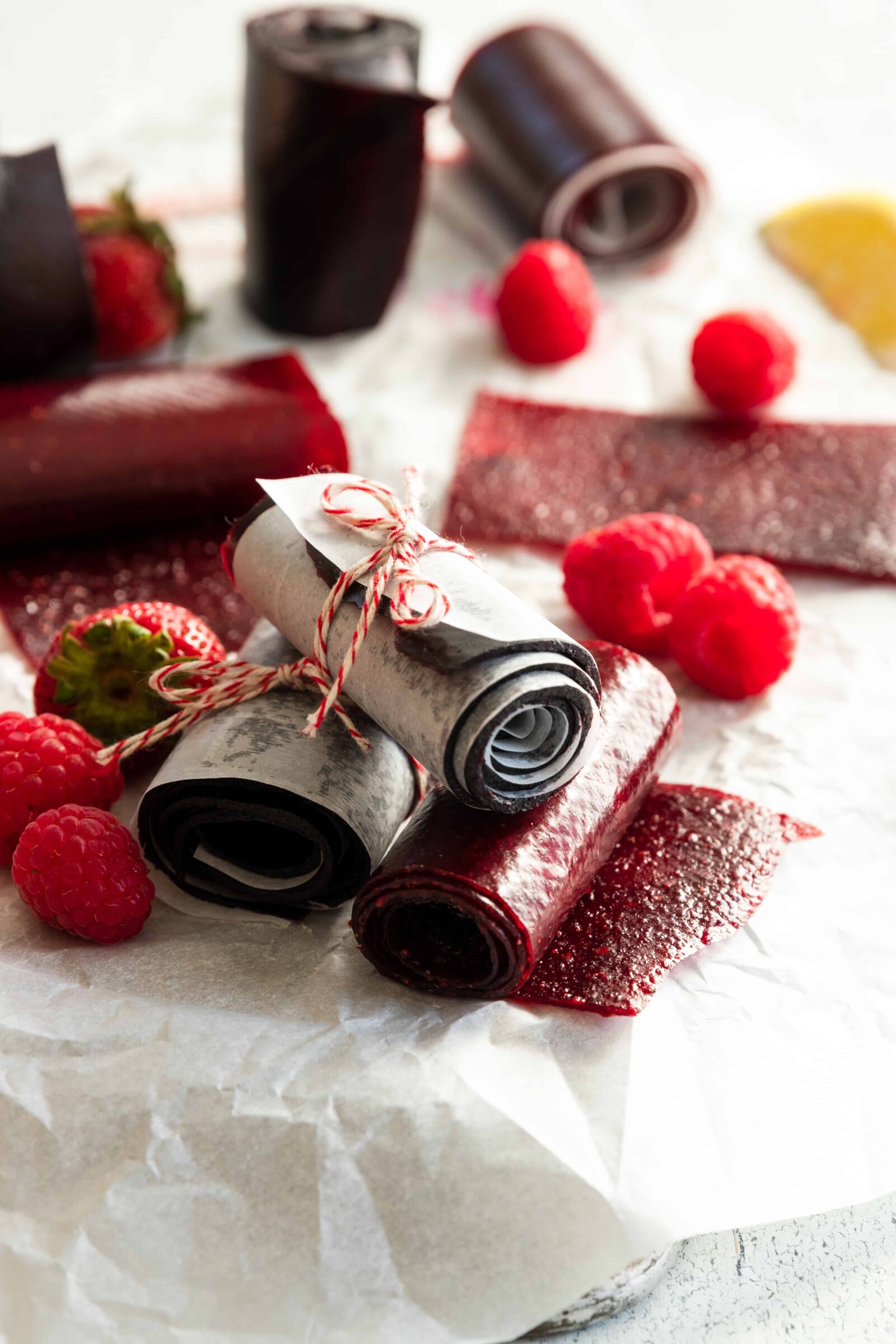 Homemade Fruit Leather rolled up with fresh fruit