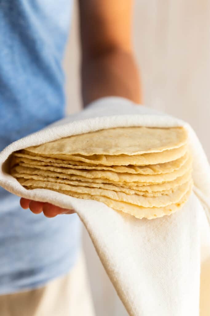 Holding a stack of Corn Tortillas