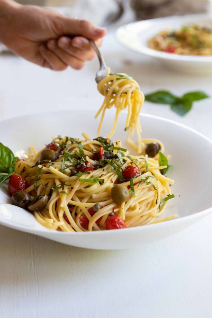 Vegan Mediterranean On-Pot Pasta served in a pasta bowl with a fork