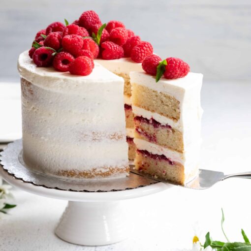 Vegan Lemon Raspberry Cake being cut and served