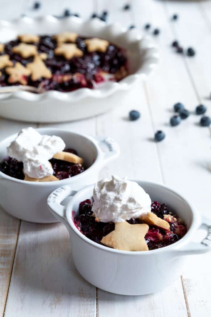 Blueberry Pie Crisp Served in Two White Dishes