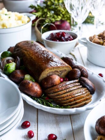 Holiday Roast served on a plate with mashed potatoes and cranberry sauce