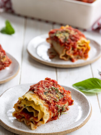 Lasagna Roll Ups with Vegan Ricotta and Spinach served on three plates