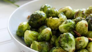 Roasted Garlicky Brussel Sprouts in a white Bowl