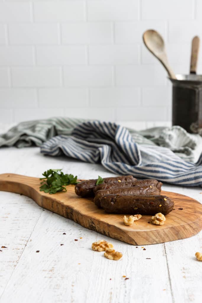 Easy Vegan Spicy Sausages Served on a Wooden Cutting Board