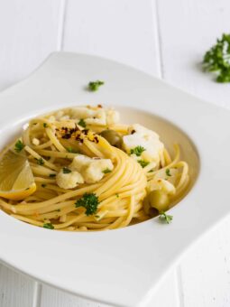 One-Pot Linguine Pasta with Cauliflower, Lemon, and Olives served on a white plate