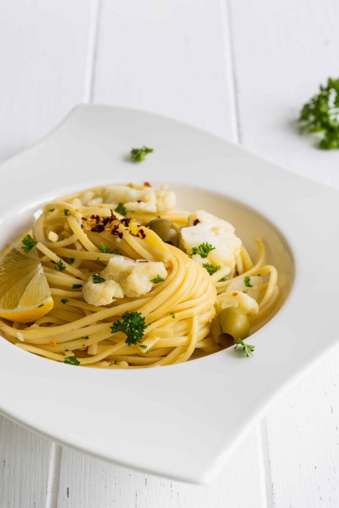 One-Pot Linguine Pasta with Cauliflower, Lemon, and Olives served on a white plate