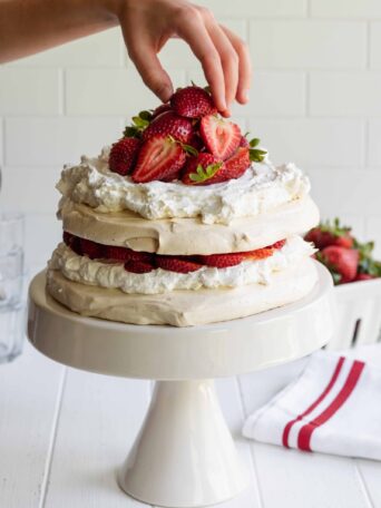 Vegan Pavlova Cake served with fresh strawberries