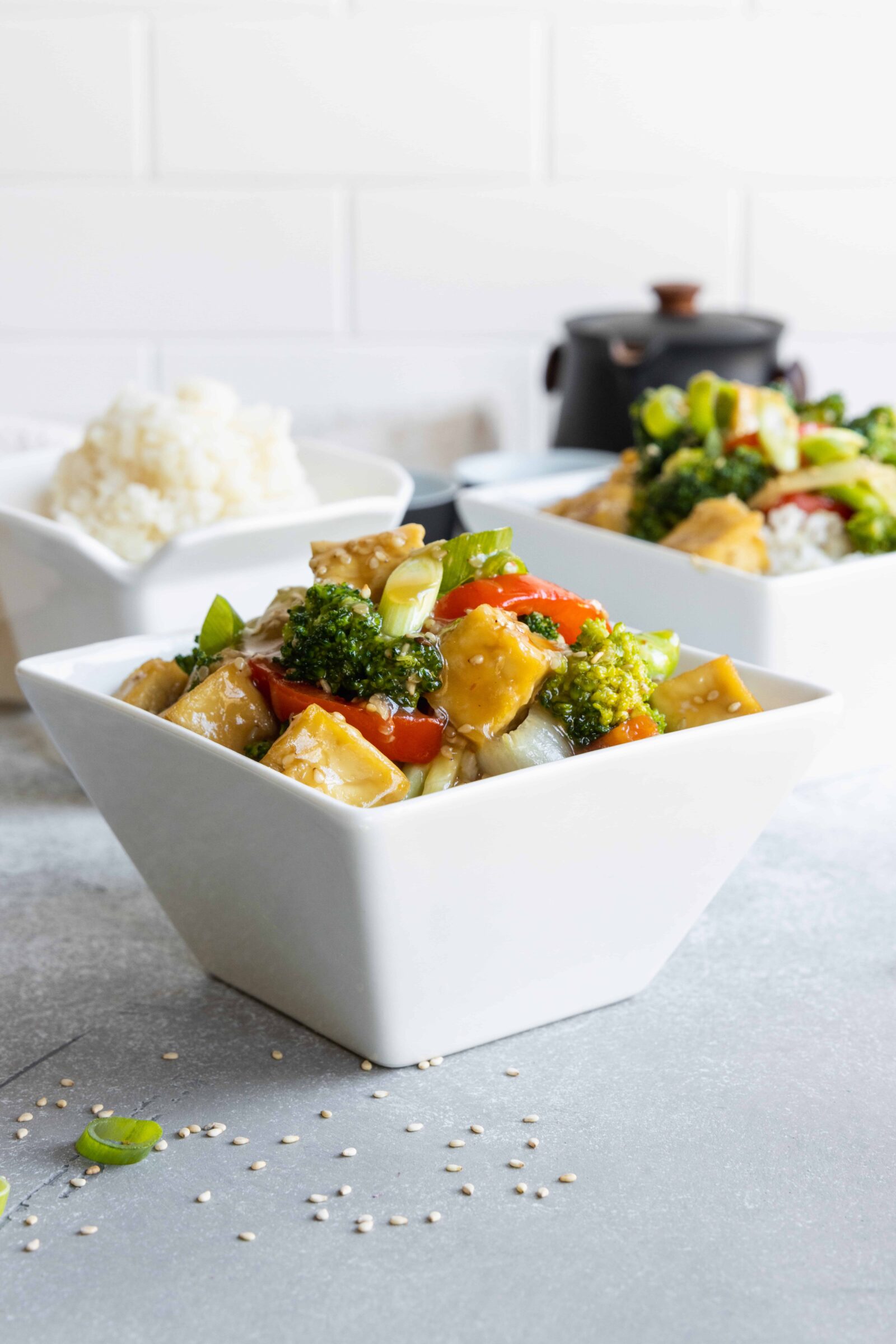 Crispy Sesame Garlic Tofu with Vegetables served in a white square bowl