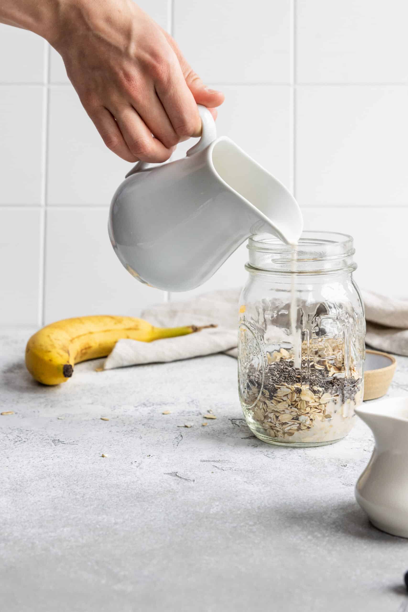 Adding plant-based milk to a mason jar