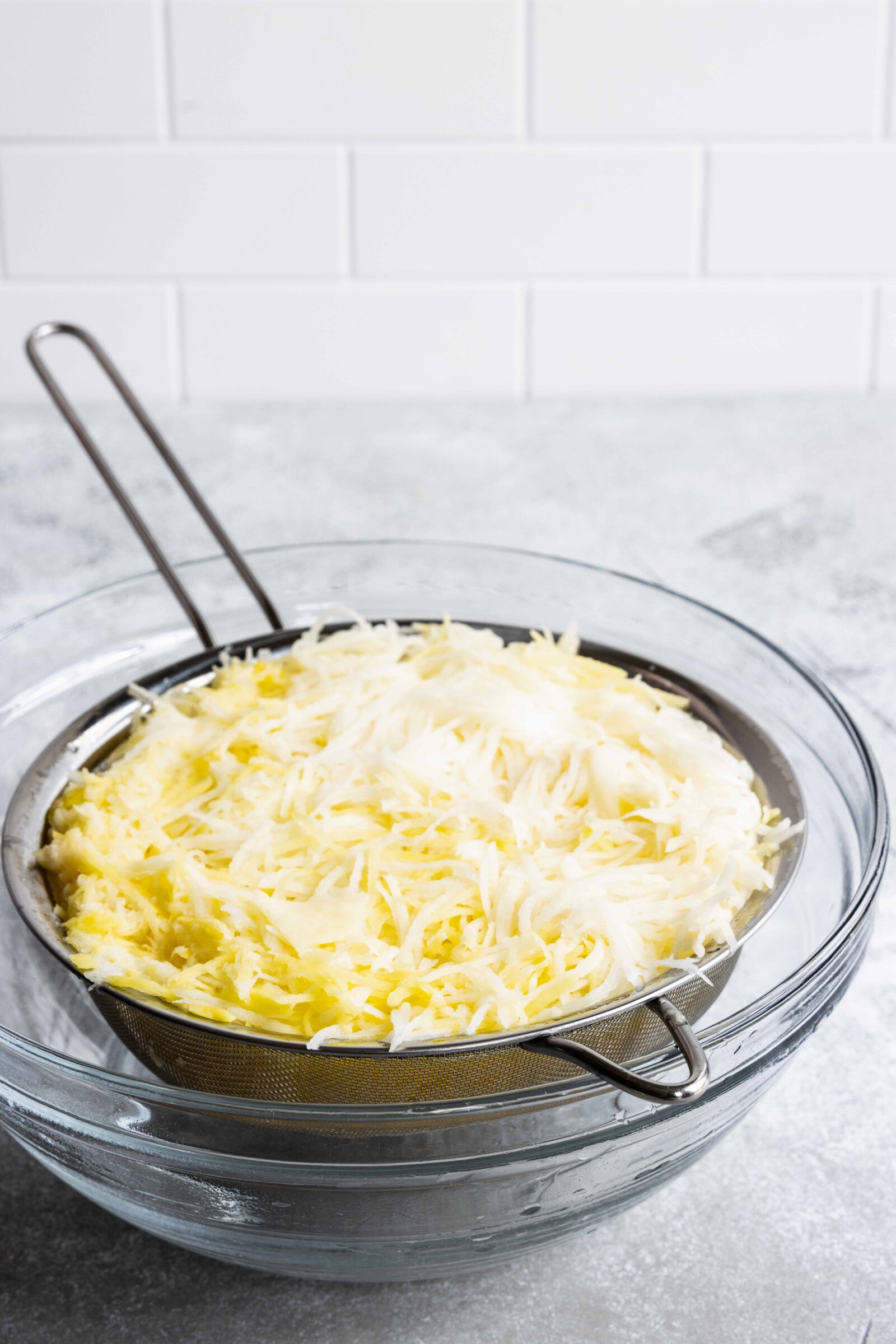 Rinsing the shredded potatoes