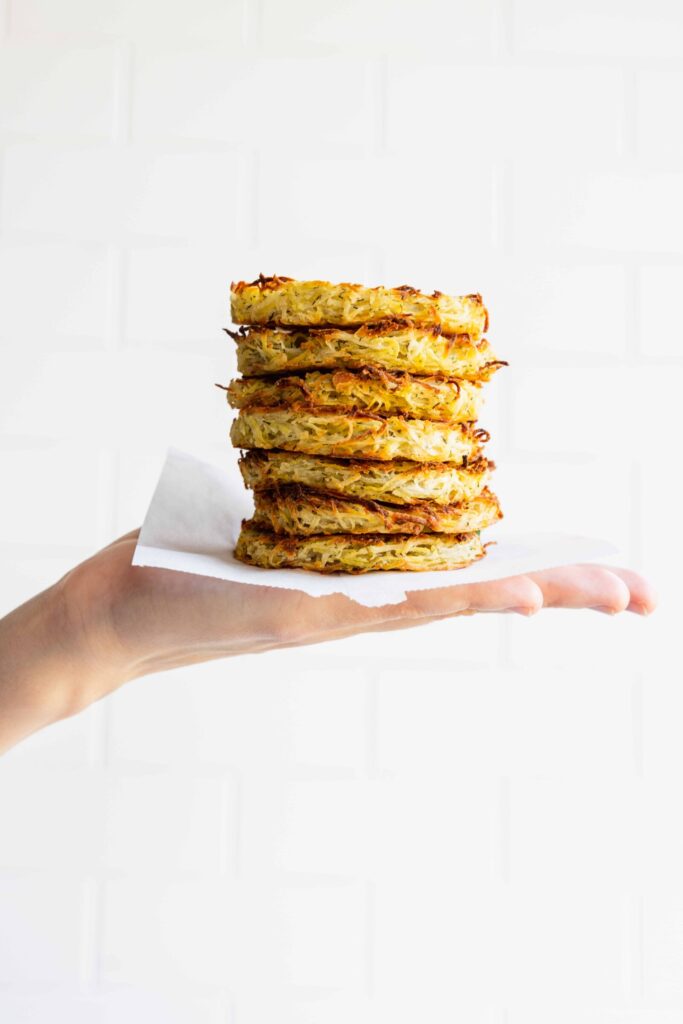 Holding a stack of crispy hash browns