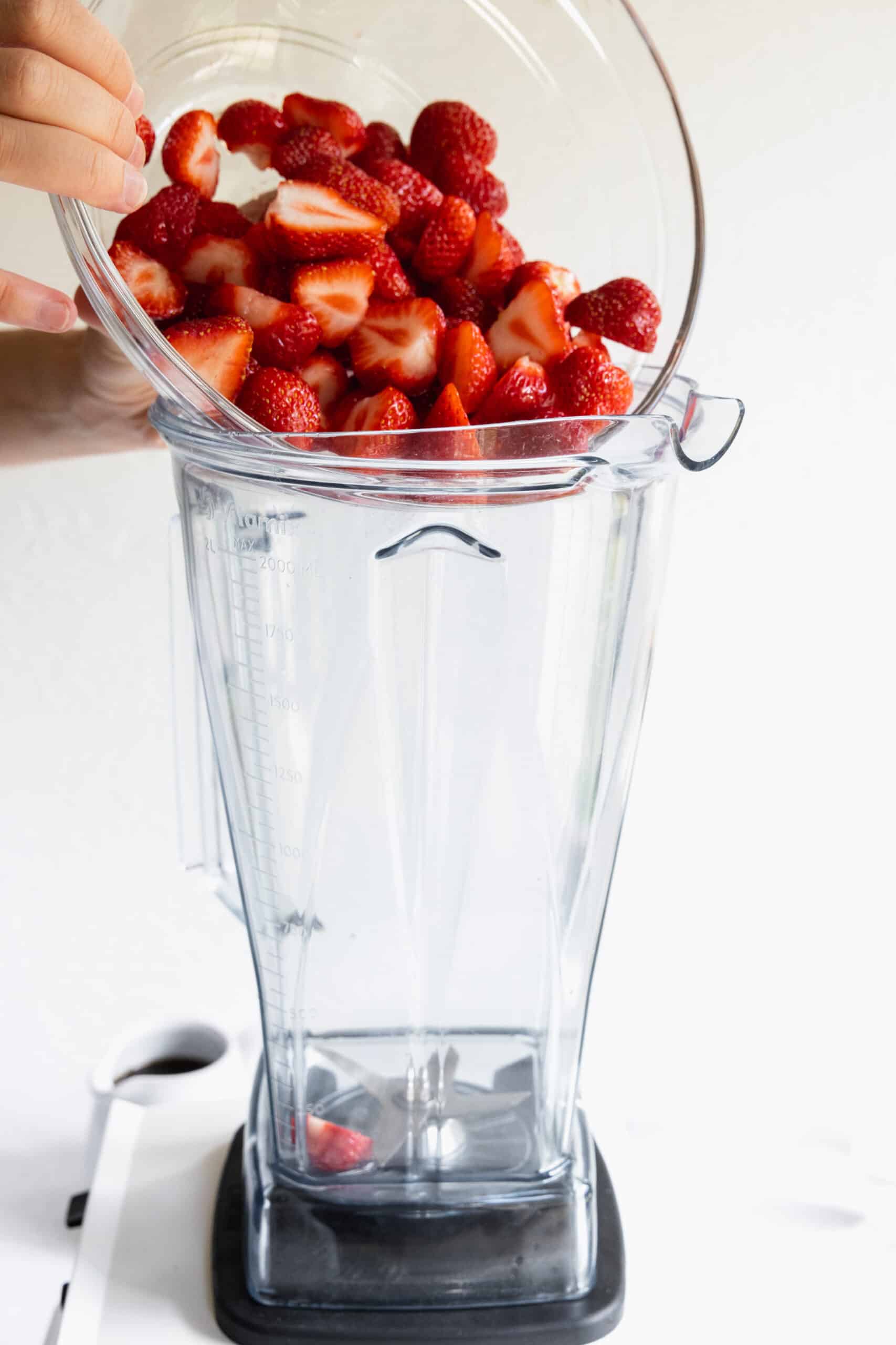 Adding Fresh Strawberries to a blender