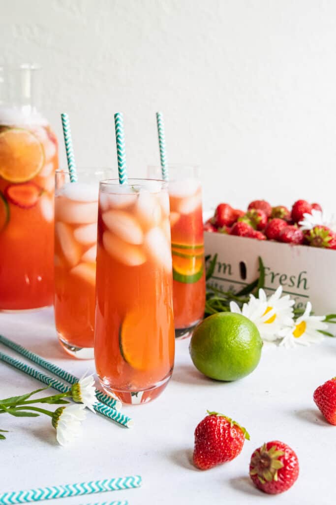 Strawberry Limeade in three tall glasses with strawberry and lime slices