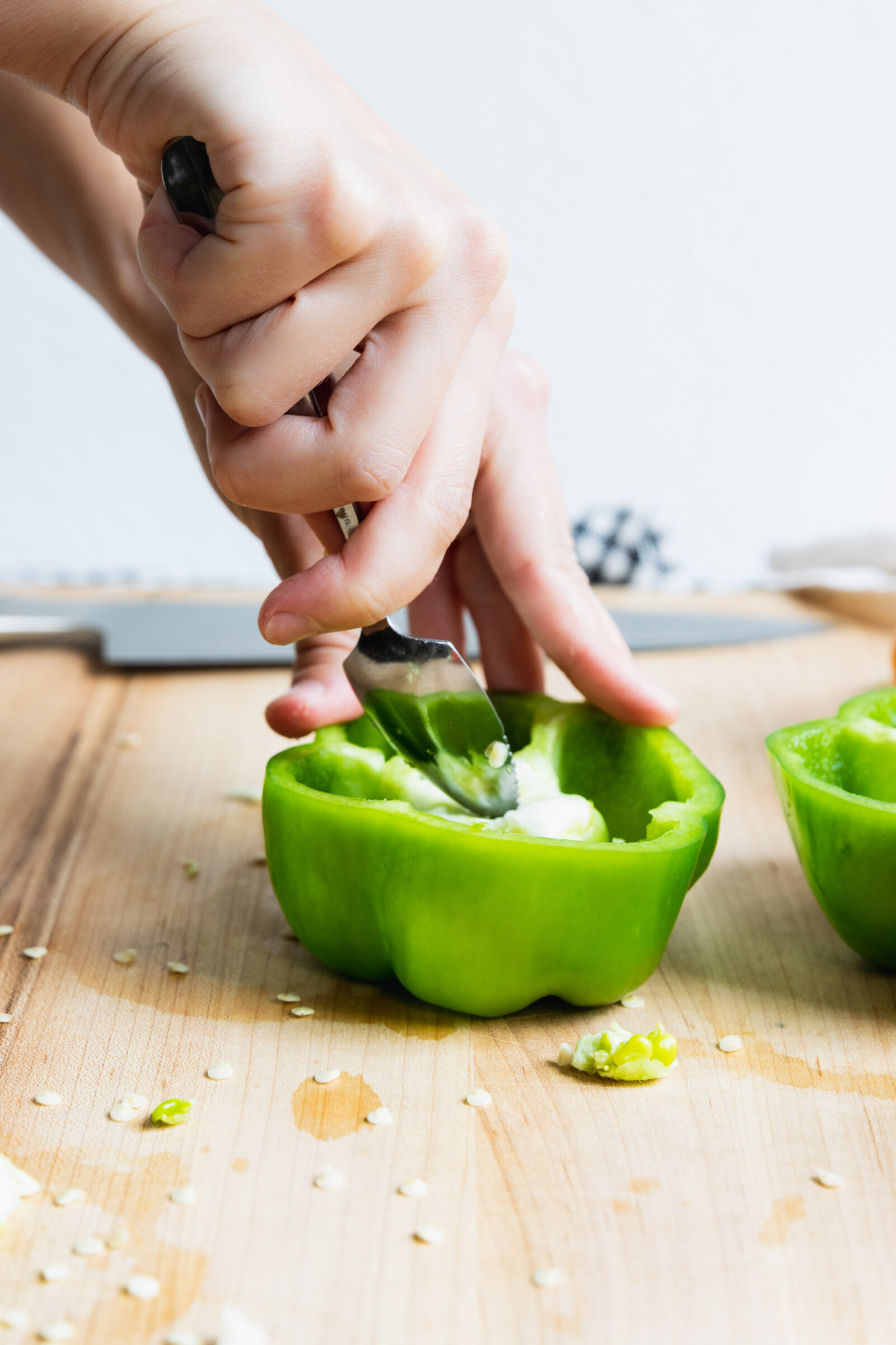 Removing the seeds from the green pepper