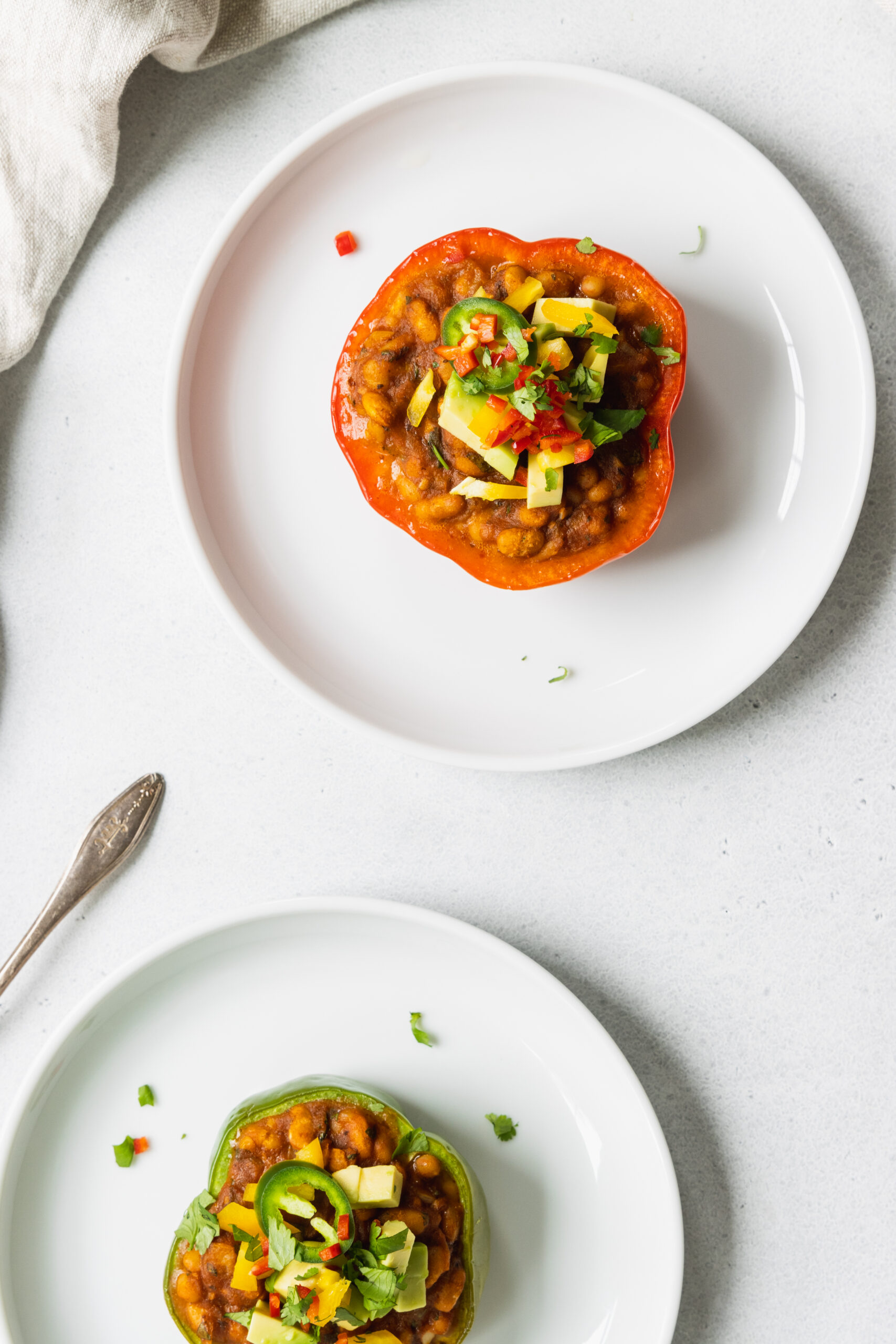 Vegan Stuffed Peppers served on two white plates