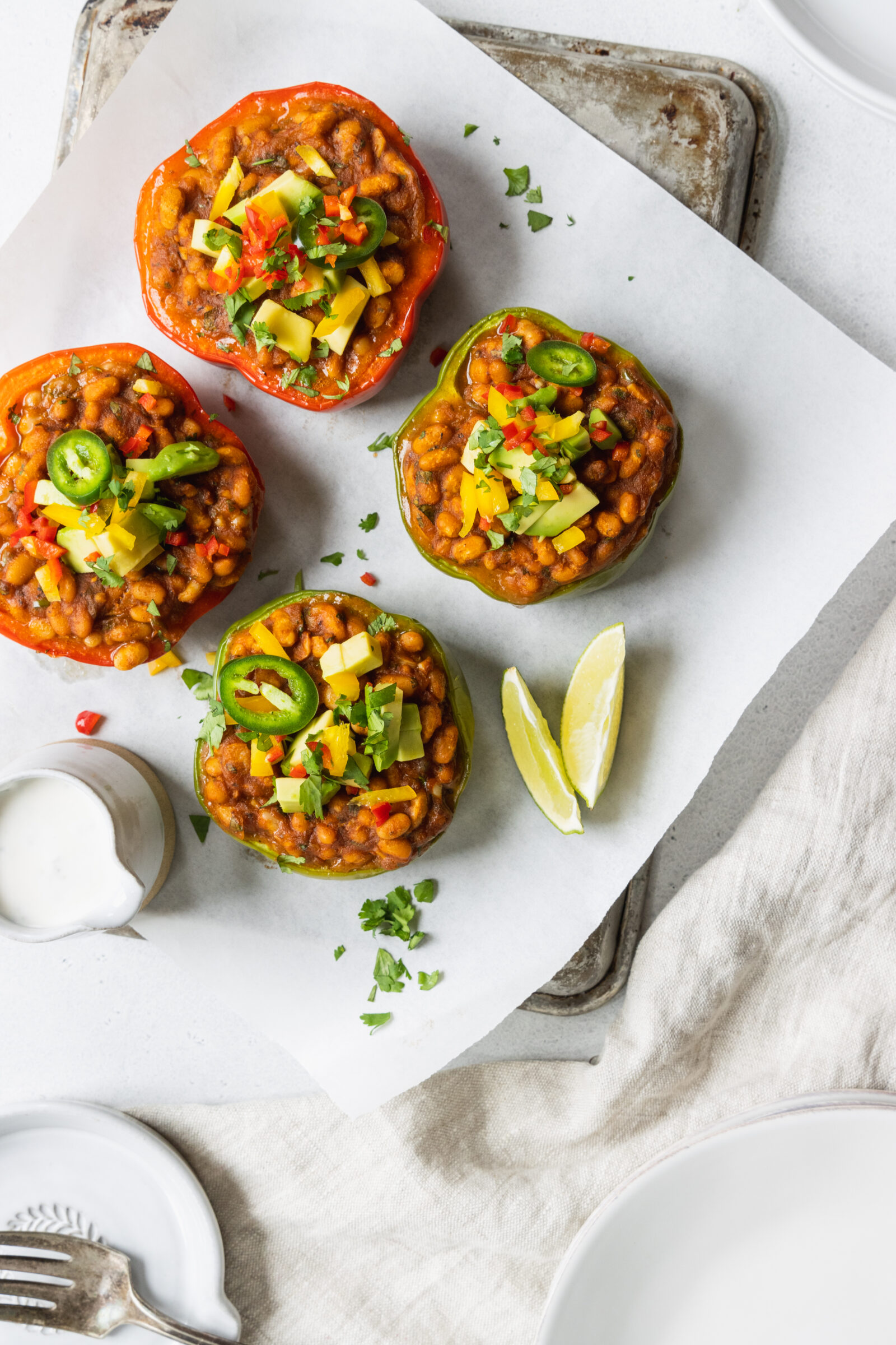 Vegan Stuffed Peppers served with fresh avocado and cilantro