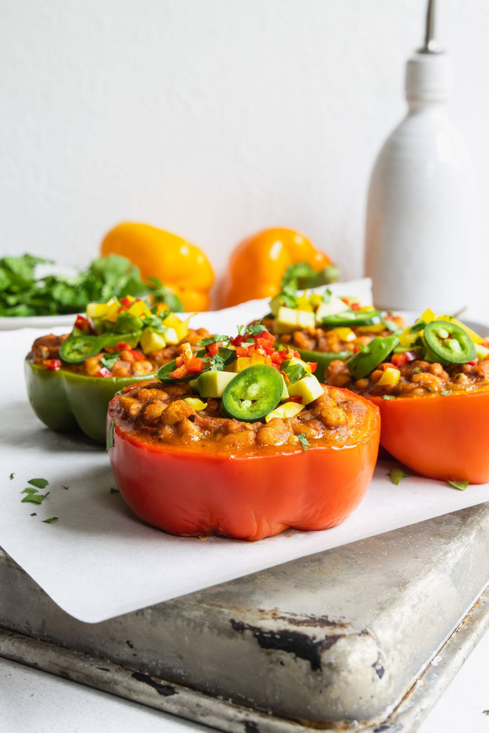 Vegan Stuffed Peppers served with fresh avocado and cilantro