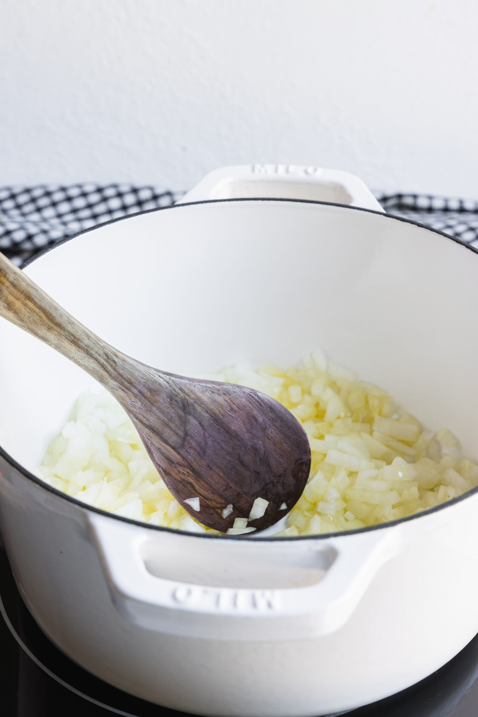 Sautéing onions in a pot for plant beef chili