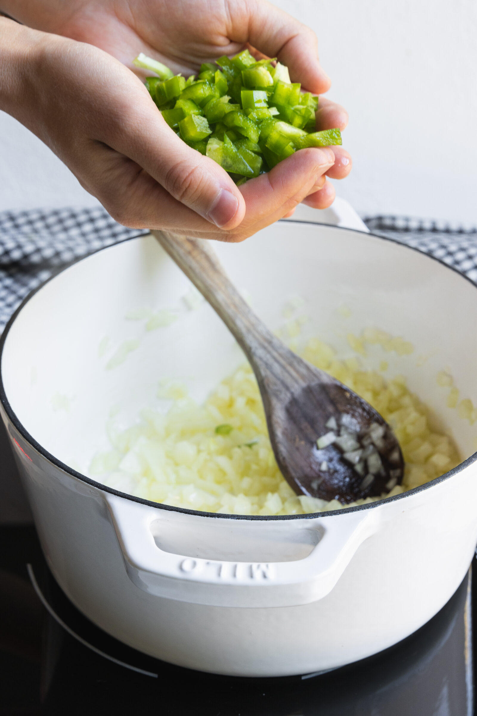 Adding chopped green pepper