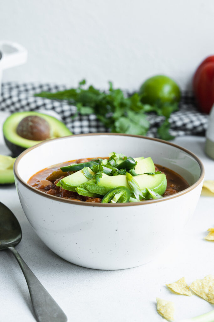 Plant based bean chili served with avocado