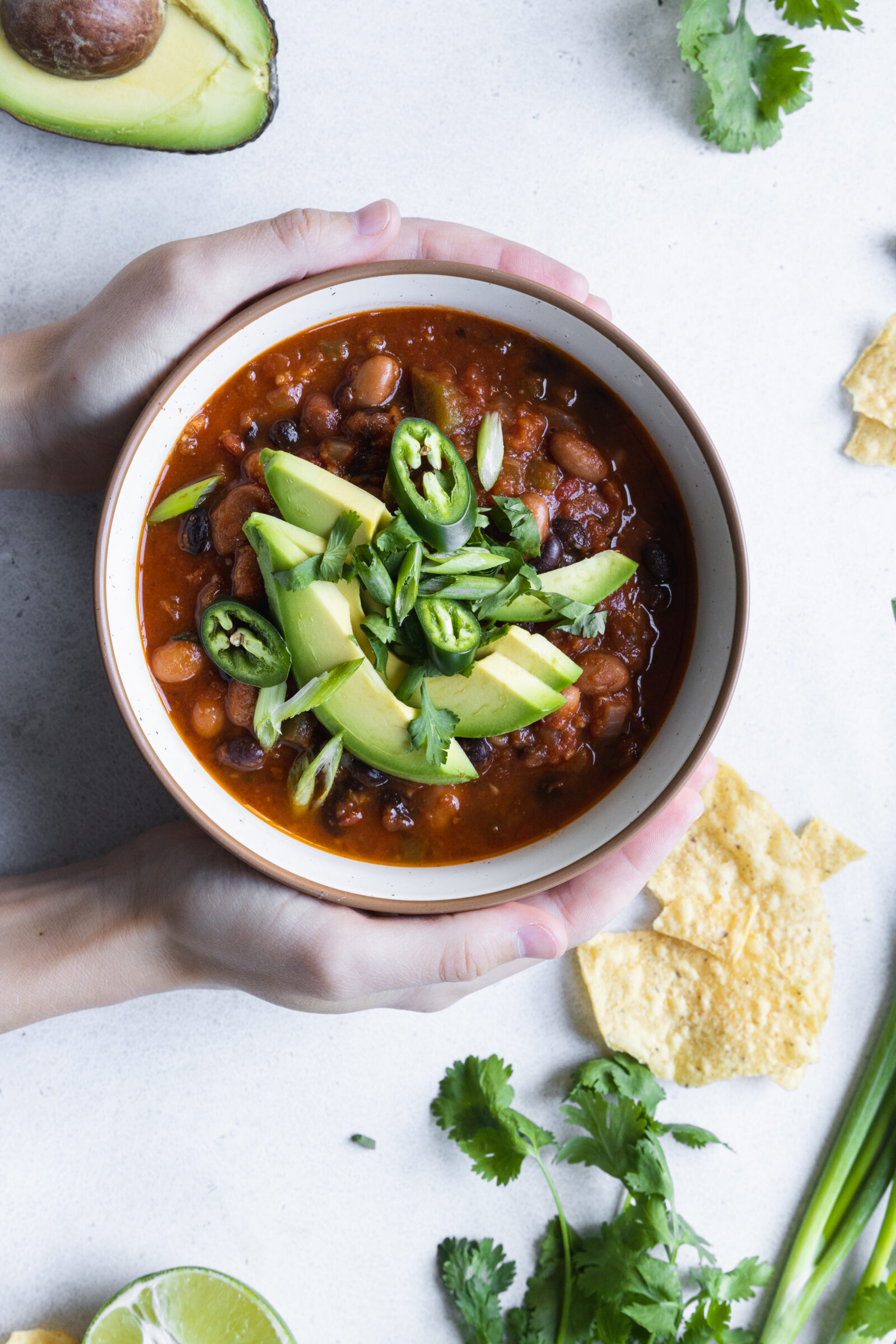 Vegan chili recipe with avocado, lime, and jalapeño