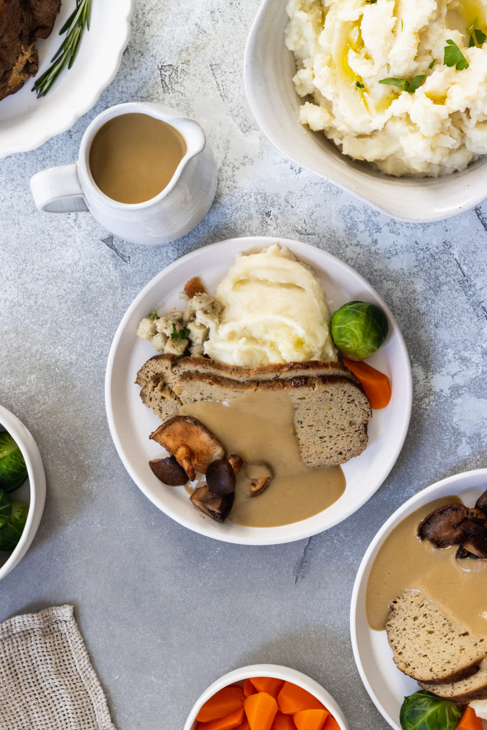 Vegan turkey roast with gravy mushrooms, mashed potatoes, and vegan gravy