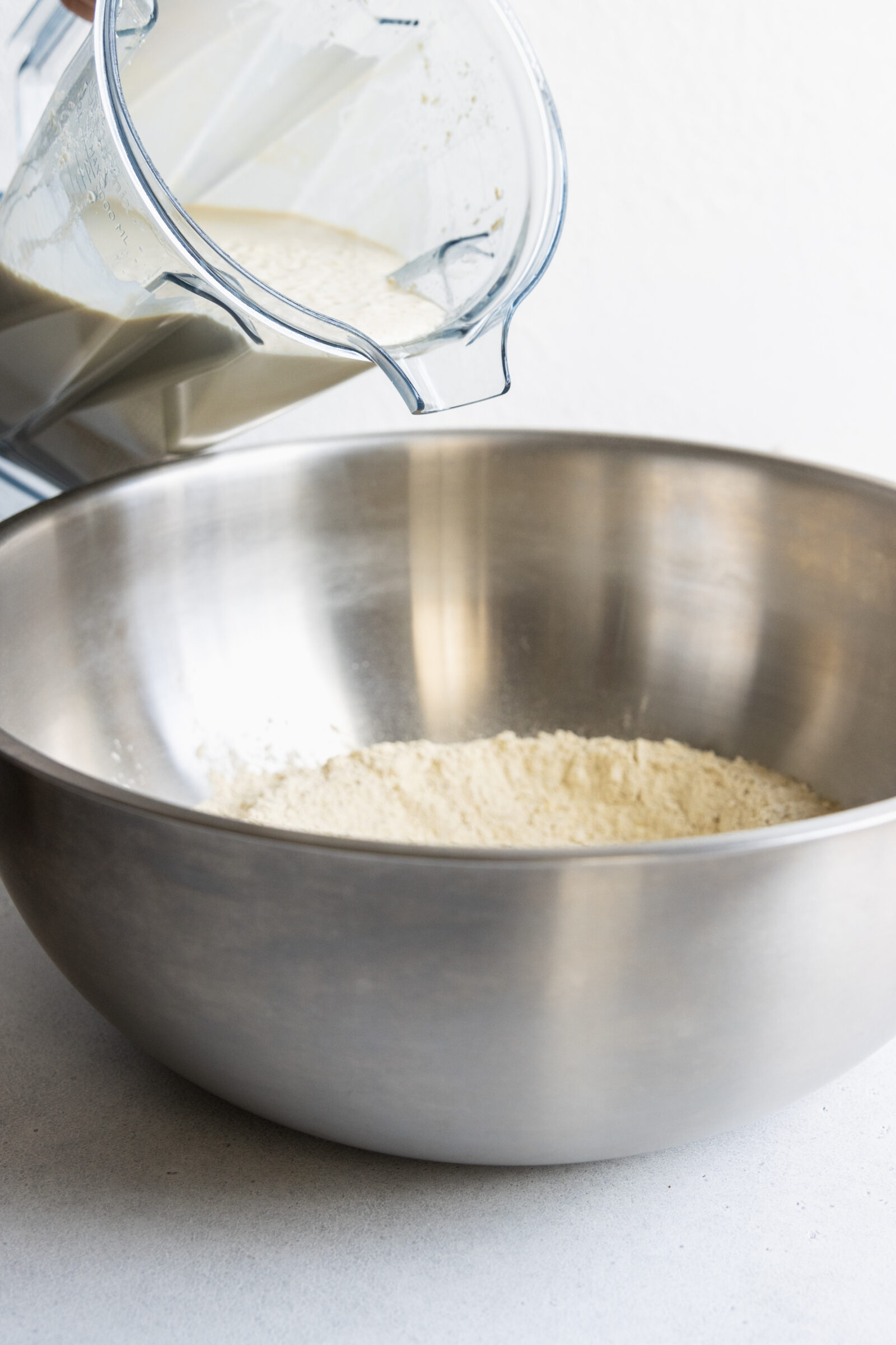 Adding the wet ingredients to a large bowl