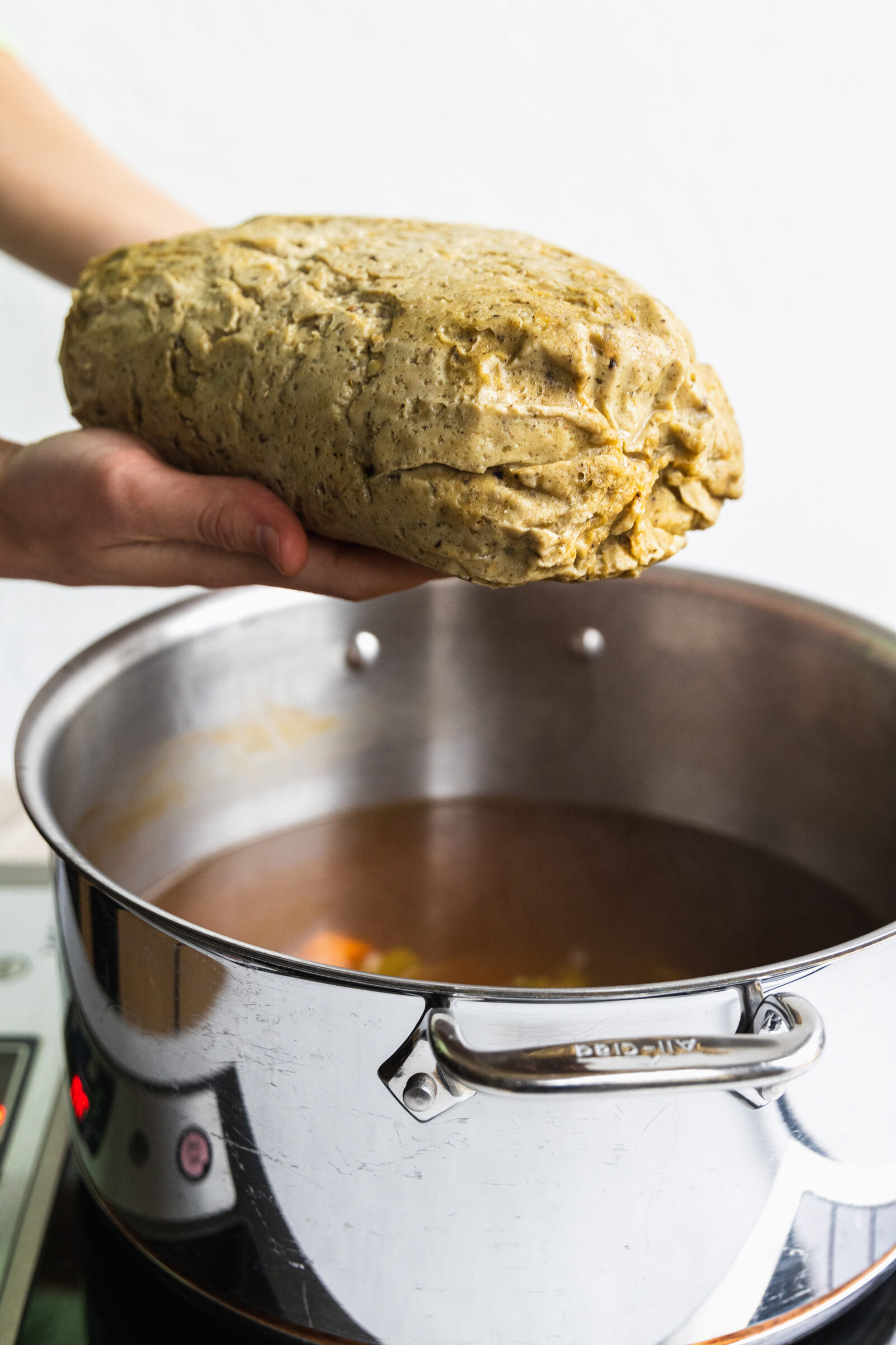 Adding the vegan turkey roast to the broth