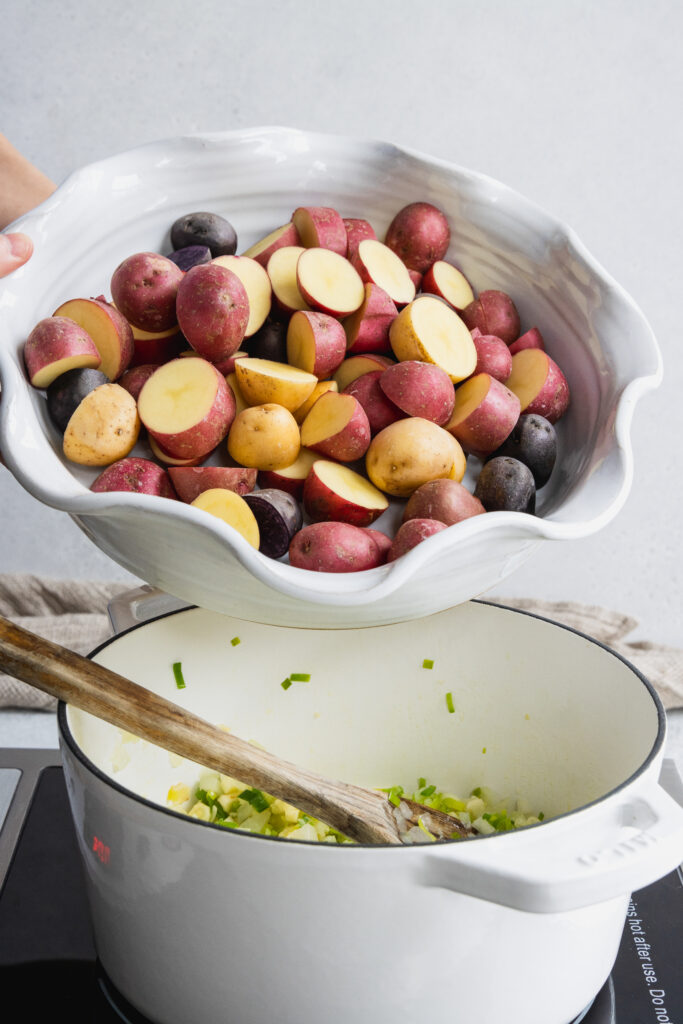 Adding the potatoes to the pot