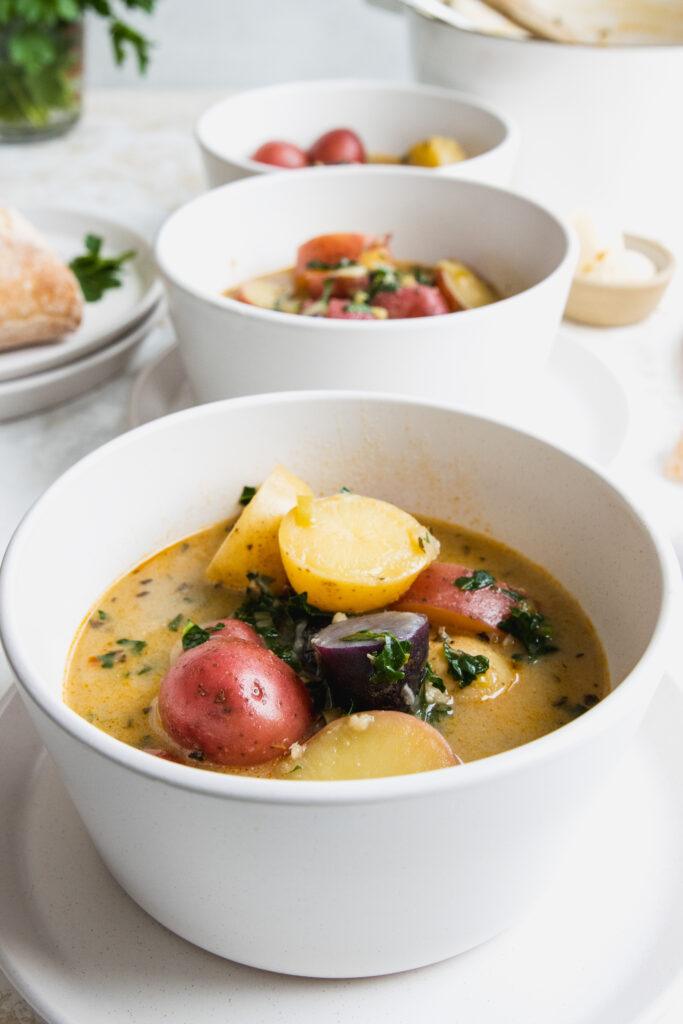 Bacon potato kale soup circuit two white bowls