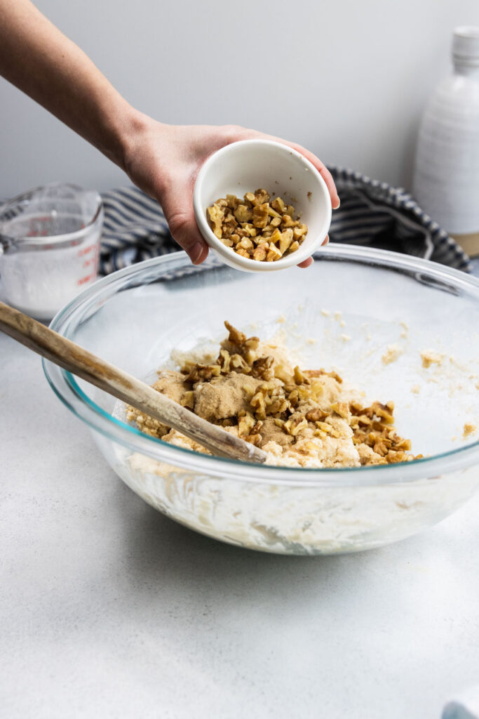 Adding chopped walnuts to the scone dough