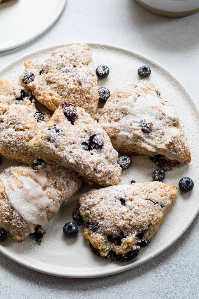 Vegan blueberry scones served with extra fresh blueberries