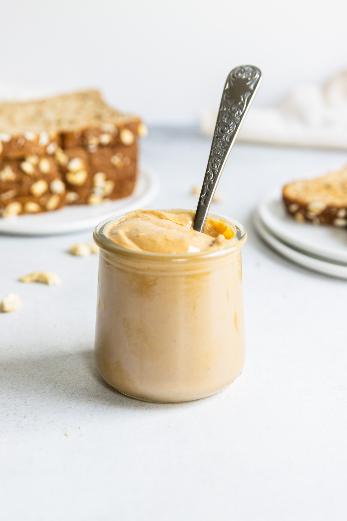 Homemade cashew butter in a glass jar with a spoon